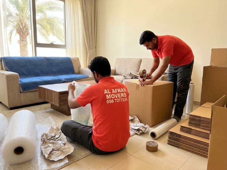 Al Afnan packers wrapping glassware and furniture in bubble wrap and stretch film